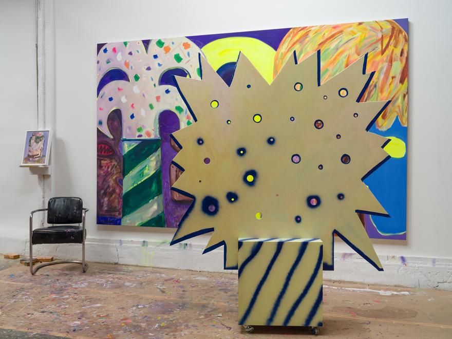 View of the studio, 2026 (foreground: Kapow! Tree Screen , 2025. Plywood, gesso and acrylic paint and wheels, 76 x 60 x 12 inches); background: Unidentified Object , 2025–26. Oil on canvas, 80 x 128 inches). Photo: Jeff McLane.