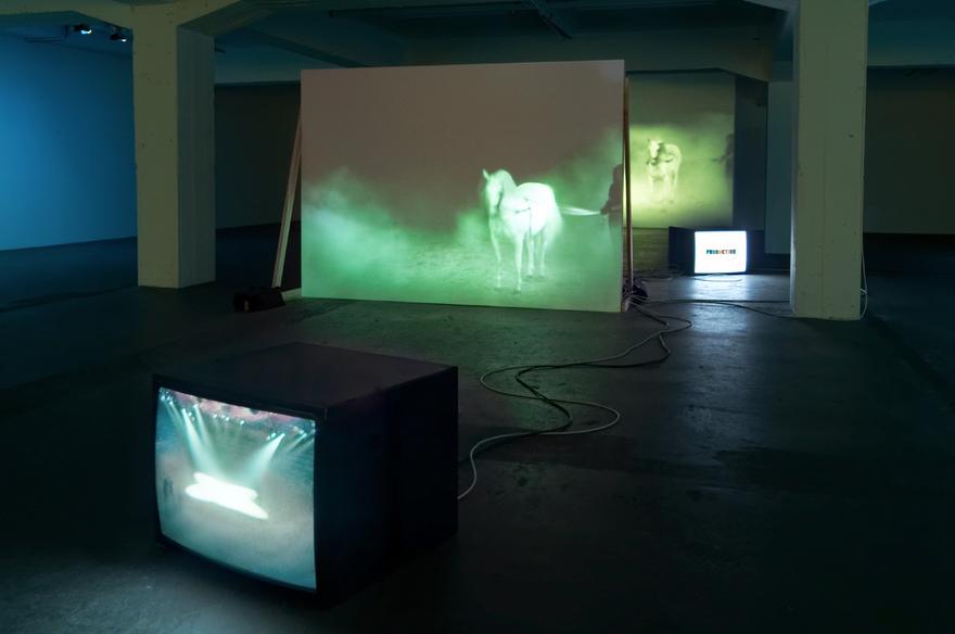 The Best Space is the Deep Space , 1998 Two (2) video projectors, two (2) video monitors, four (4) media players, free standing wall and existing architecture Installation View, Hamburger Bahnhof-Museum fur Gegenwart, Berlin, Germany, 2006 