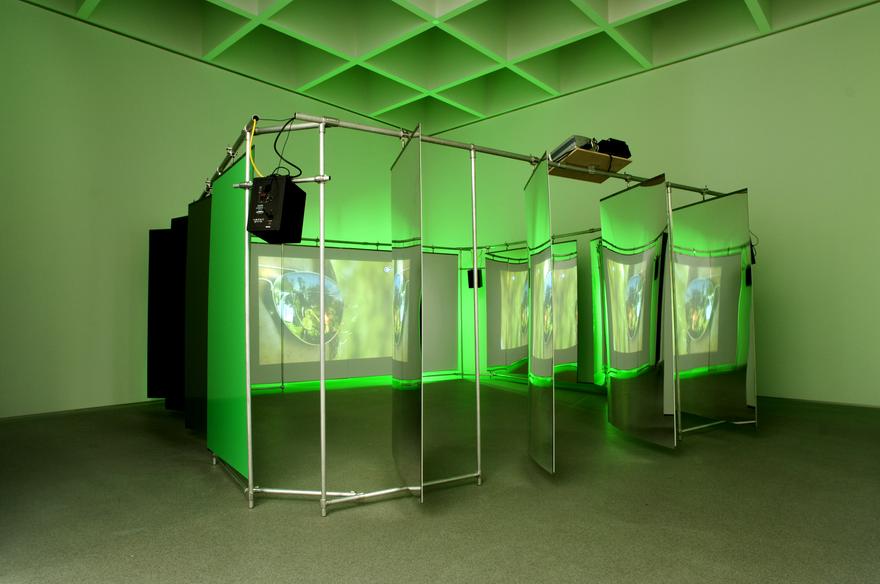 relay, 2007 One (1) media player with 5.1 Surround Encoder, one (1) video projector, four (4) speakers, Plexiglas, aluminum and fluorescent tubes Installation view, Pinakothek der Moderne, Munich, Germany, 2007 Photo by Haydar Koyupinar