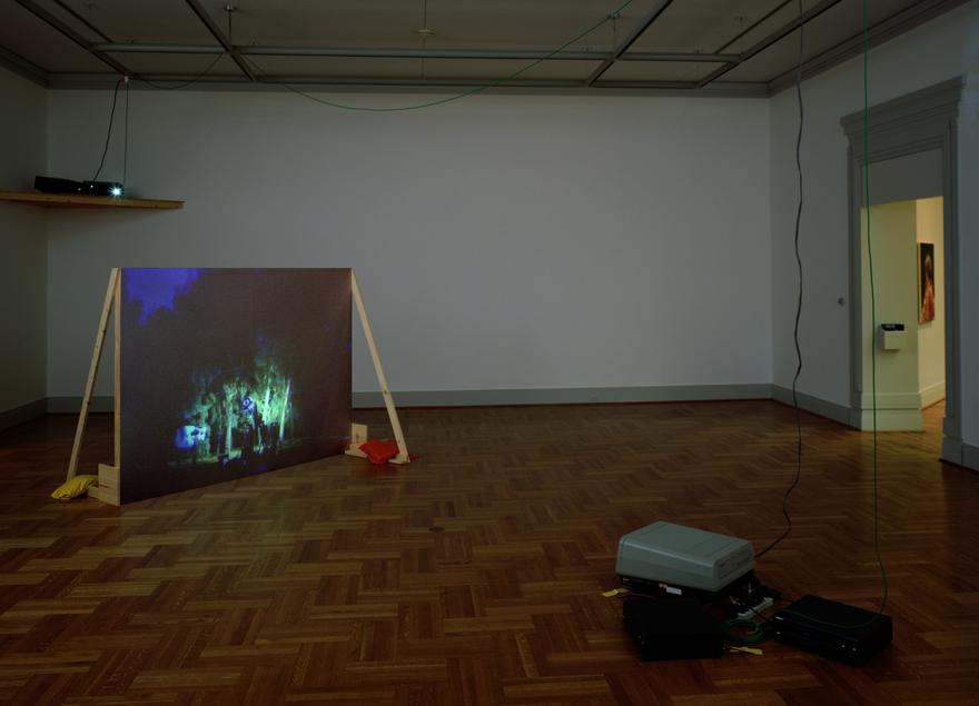 The best outside is the inside, 1998 Three (3) video projectors, three (3) media players, free standing wall and existing architecture Dimensions variable Installation view, The Saint Louis Art Museum, St. Louis, Missouri 