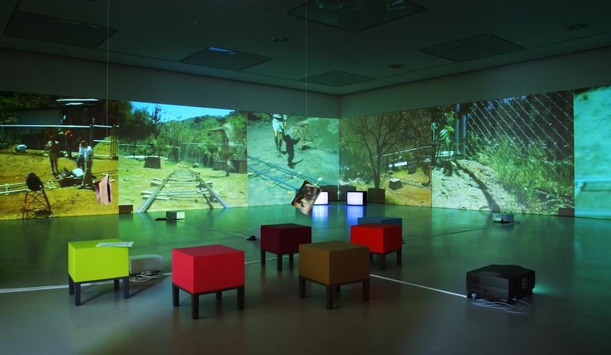 Electric Mind, 1996 Six (6) video projectors, two (2) video monitors, eight (8) media players, one (1) synchronizer, Lee filters and existing architecture Dimensions variable Installation view, Museum van Hedendaagse Kunst Antwerpen, Antwerp, Belgium, 2004  Photo by Lieven Herremans